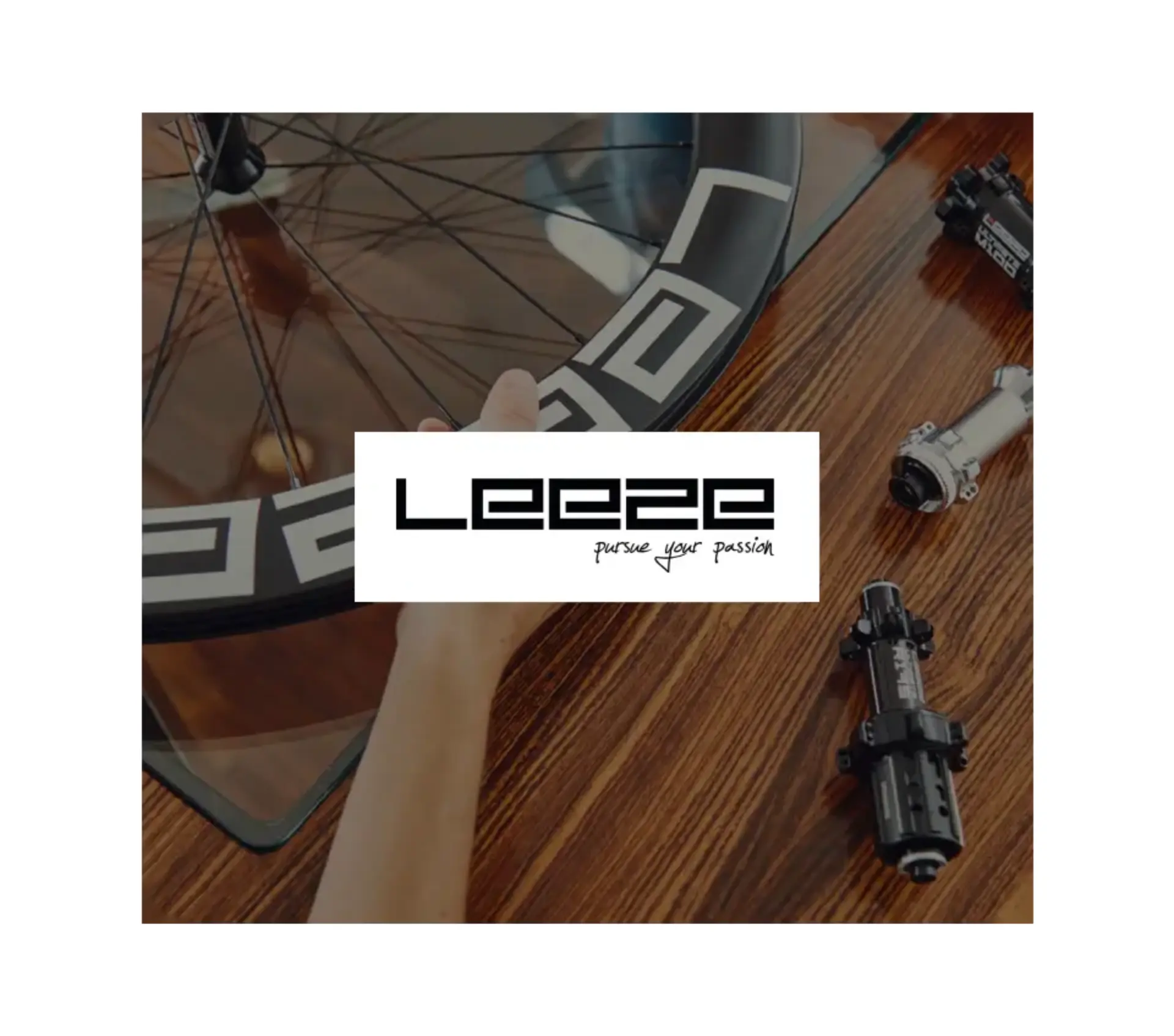 The "Leeze - pursue your passion" brand logo in a white box, overlaid on a background showing a bicycle wheel rim and various high-quality bike hubs on a polished wooden table.Xentral ERP for bike retail: 